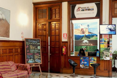 a restaurant with a door with a menu and a chalkboard at 1900 Backpacker's Hostel in Lima
