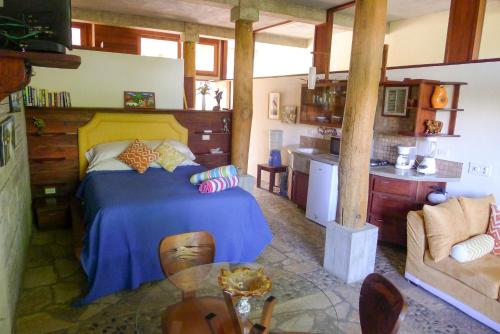 a bedroom with a large bed and a kitchen at Luxury Studio Apartment with all the Trimmings in San Juan del Sur