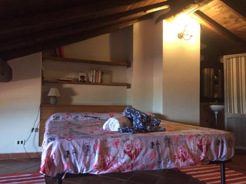 a baby laying on a bed in a room at casa accogliente vista lago in Alserio