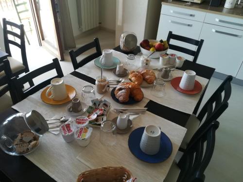 a dining room table with breakfast foods on it at Guest House Domus Cicerone in Formia