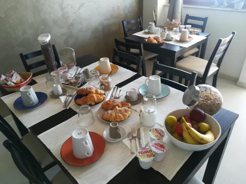 a table with food and a bowl of fruit on it at Guest House Domus Cicerone in Formia