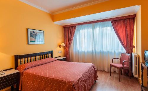 a hotel room with a bed and a window at Hotel Isolino in O Grove