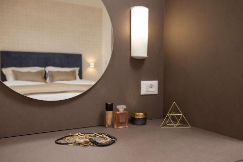 a bedroom with a mirror and a bed with a bed sqor at Villa Four Brothers - Middle Floor in Podstrana