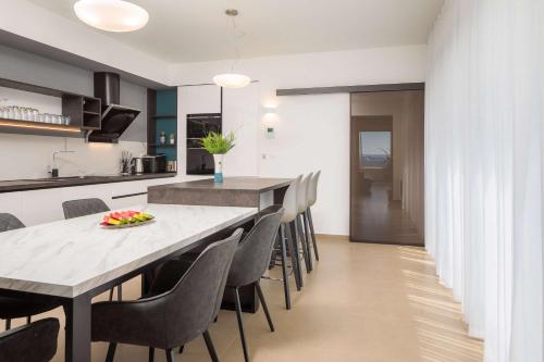 a kitchen and dining room with a table and chairs at Villa Four Brothers - Middle Floor in Podstrana
