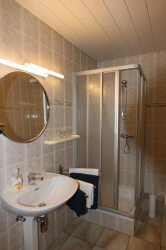 a bathroom with a sink and a shower at W.I.P. Welt im Park in Dresden