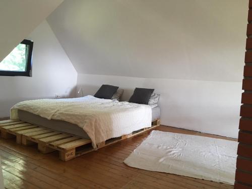 a bedroom with a bed on a wooden platform at KÉSA Faház in Balatonlelle