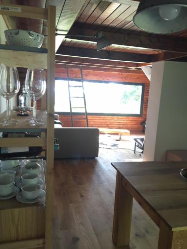 a kitchen with a ladder and glasses and a table at KÉSA Faház in Balatonlelle