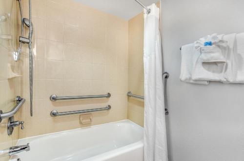 a bathroom with a tub and a shower with a shower curtain at Holiday Inn Express & Suites Morristown by IHG in Morristown