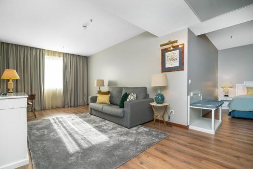 a living room with a couch and a bed at Gaia Residence in Vila Nova de Gaia