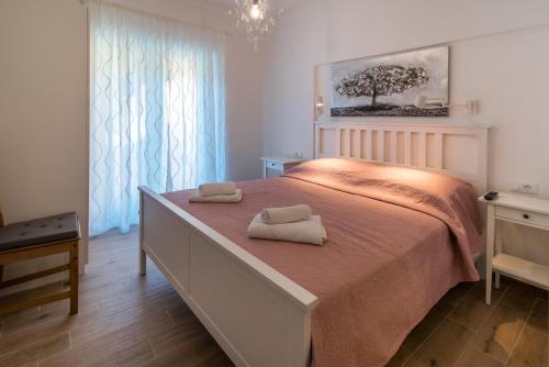 a bedroom with a bed with two towels on it at Villa Natura in Vrbnik
