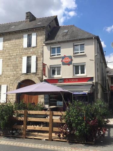 a building with an umbrella in front of it at Set A Table in Broons