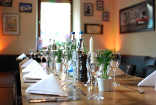 a long table with wine bottles and glasses on it at Zum Scheffelhof in Maulbronn