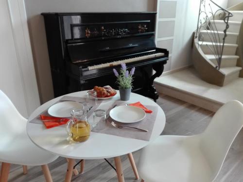 a table with a plate of food and a piano at eden in Cannobio