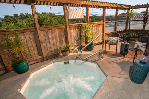 a hot tub on a patio with a fence at Shearwater Inn in Lincoln City