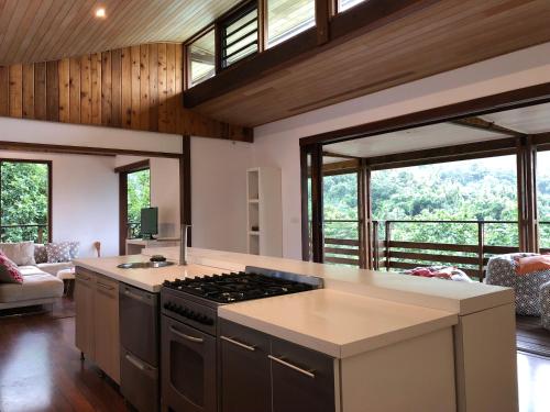 a kitchen with a stove top oven in a room at La Villa Te Fetia Nui Moorea in Teavaro