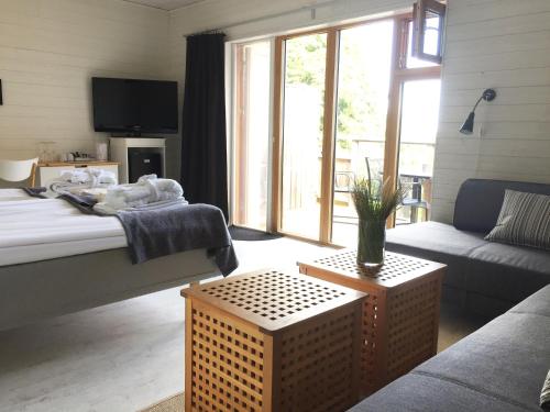 a living room with a bed and a couch at Bodelssons by the Sea in Tosteberga