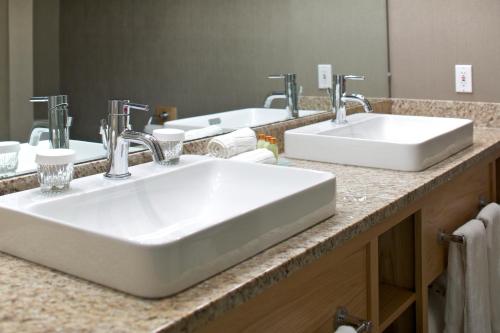 a bathroom with two sinks and a large mirror at Killington Grand Resort Hotel in Killington