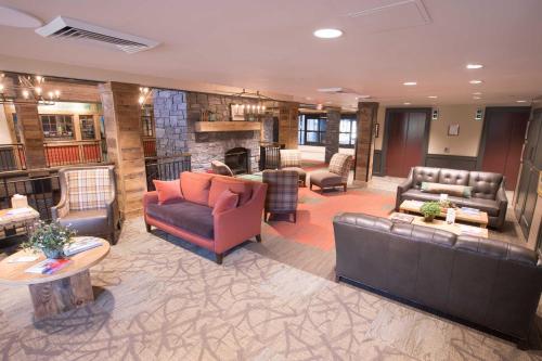 a large living room with couches and a fireplace at Killington Grand Resort Hotel in Killington