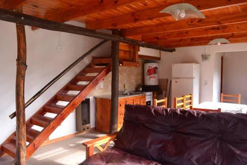 a living room with a staircase and a couch at Cabañas Paraiso Duplex 7 solo familias in Mar del Plata