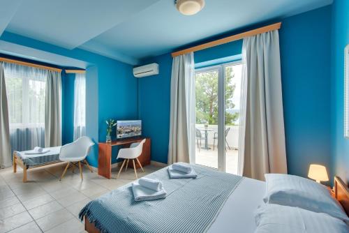 Schlafzimmer mit blauen Wänden, einem Bett und einem Schreibtisch in der Unterkunft B&B Galija in Crikvenica