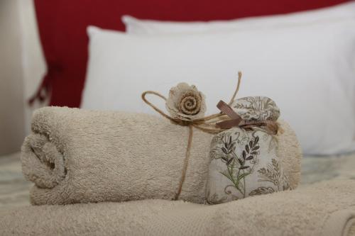 a pillow with a flower on top of a bed at Tivoli Casa Belvedere in Tivoli