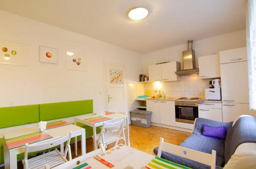 a living room with a table and a kitchen at Guesthouse GreenSLO in Ljubljana