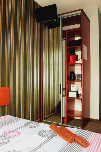 a room with a bed with a mirror and a closet at Stacja Grand in Szczecin