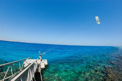 a person is flying a kite over the ocean at Luxury Villa with pool in Hurghada in Hurghada