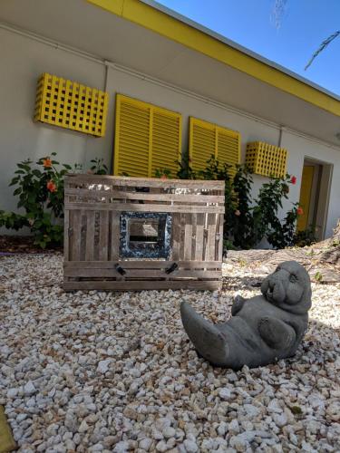 a statue of a teddy bear sitting next to a wooden box at Coconut Cay Resort in Marathon