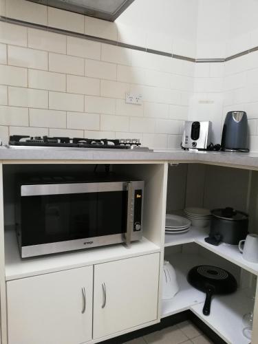 a kitchen with a microwave on a counter at City Waters in Perth