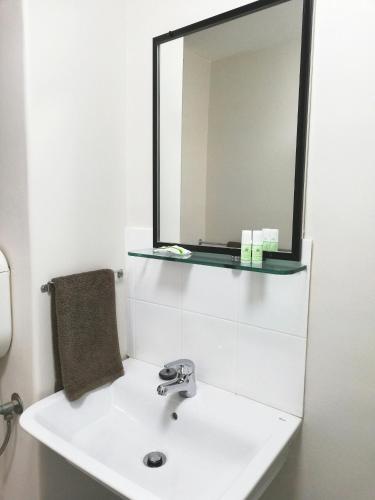 a bathroom with a white sink and a mirror at City Waters in Perth
