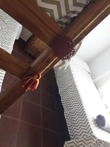 a wooden ceiling fan with a bed in a room at Cabaña Sol de Campo in La Granja