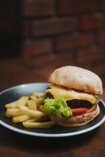 a plate with a sandwich and fries on a table at The Bricks Hotel in Dumaguete
