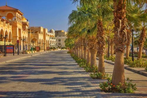a street lined with palm trees in a city at Luxury Villa with pool in Hurghada in Hurghada
