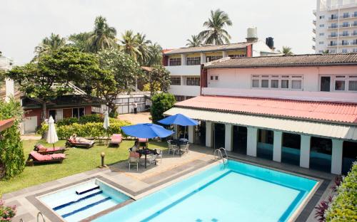 an aerial view of a hotel with a swimming pool at Ranveli Beach Resort in Mount Lavinia