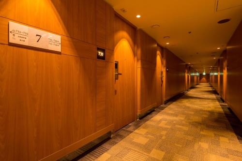 an empty hallway in a building with a sign on the wall at Nara Plaza Hotel in Tenri
