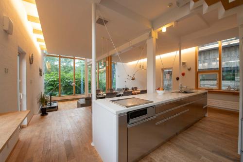 a large kitchen with a sink and a counter at Sekka House in Niseko