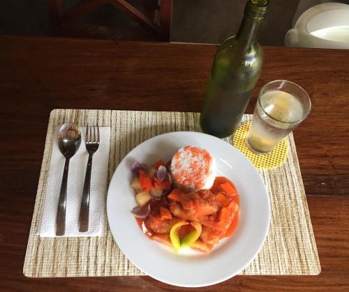 a plate of food on a table with a bottle of wine at DaRosa Del Mar in Santa Monica