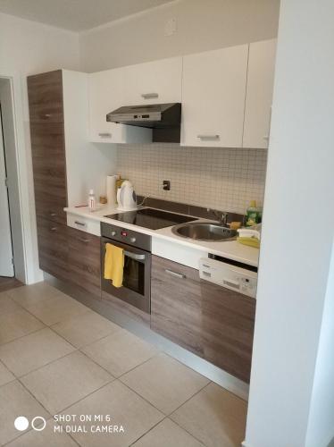 a kitchen with a sink and a stove top oven at Apartments Nogic in Peroj