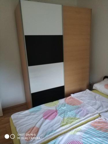 an empty bed in a bedroom with a door at Apartments Nogic in Peroj