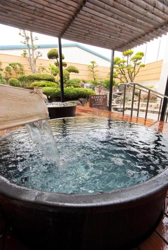 a hot tub with a water fountain in it at Nara Plaza Hotel in Tenri