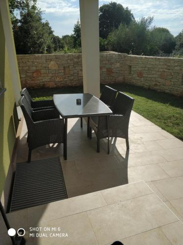 a white table and chairs on a patio at Apartments Nogic in Peroj