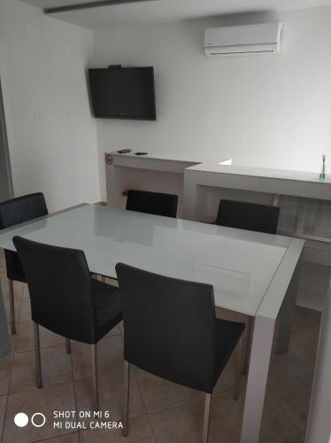 a white table and chairs in a room at Apartments Nogic in Peroj