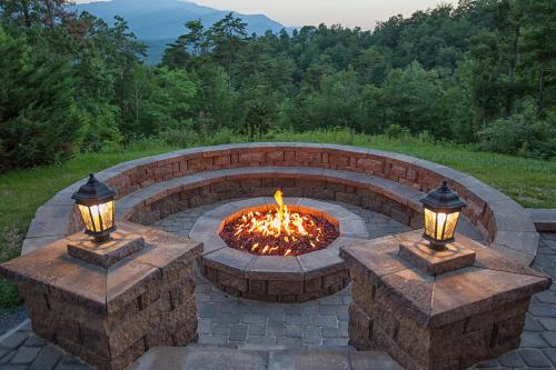 a brick fire pit with two lights on it at Gatlinburg Mansion Cabin in Pittman Center