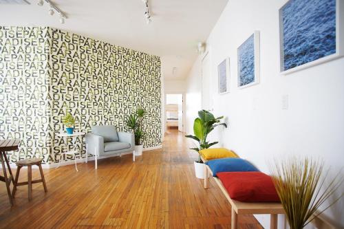 a living room with a couch and a wall at The Steady in Los Angeles