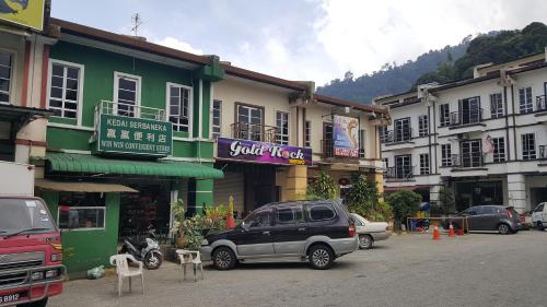 a car parked in a parking lot in front of buildings at Win Win in Genting Highlands