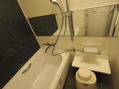 a bathroom with a sink, toilet and bathtub at Haneda Inn in Tokyo