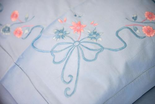 a bedsheet with a flower design on it at L' Arena Suite - Sicilian style 140 mq flat with balcony and Arena seeview in Castellammare del Golfo