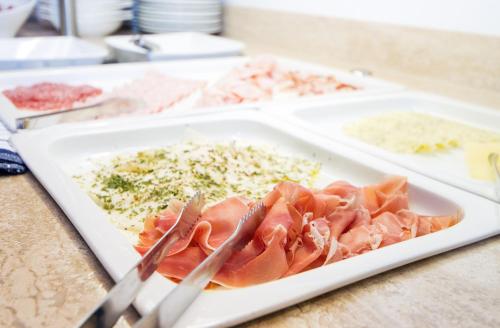 a plate of food with meat and rice on a table at Die Seefelderin - Boutiquehotel St. Georg in Seefeld in Tirol