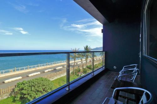 a balcony with a view of the ocean at Two Home Inn in Hualien City